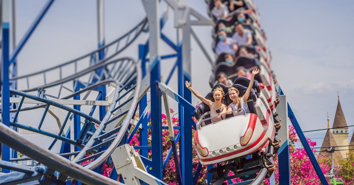 happy friends in amusement park