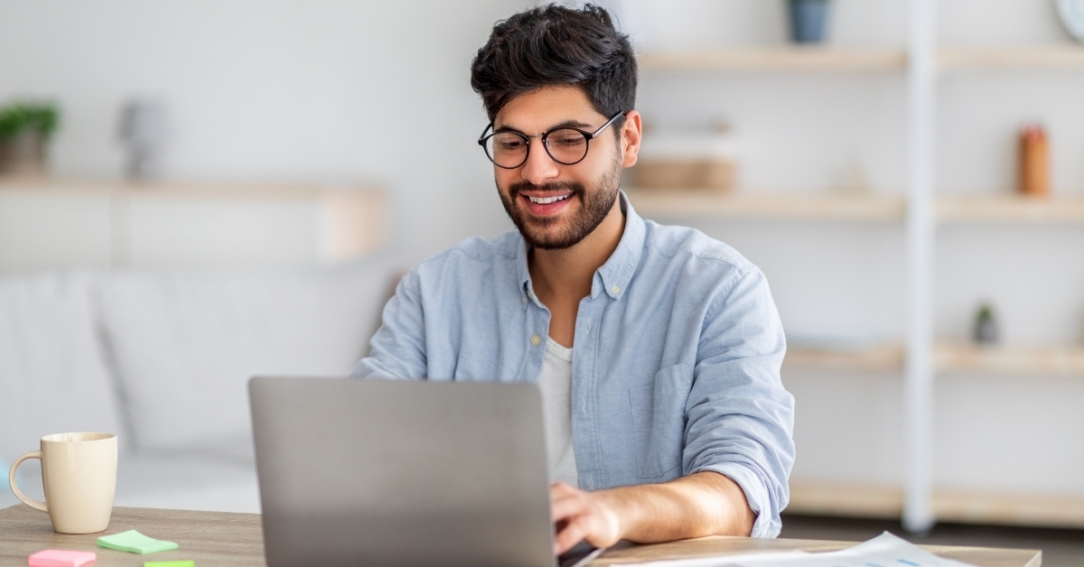 male freelancer working remotely using laptop