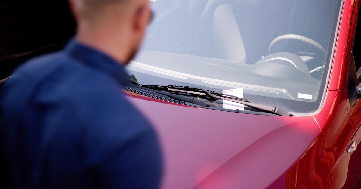 driver looking at parking ticket