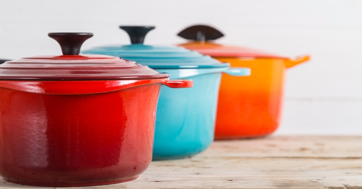 Cast iron saucepans on wooden table