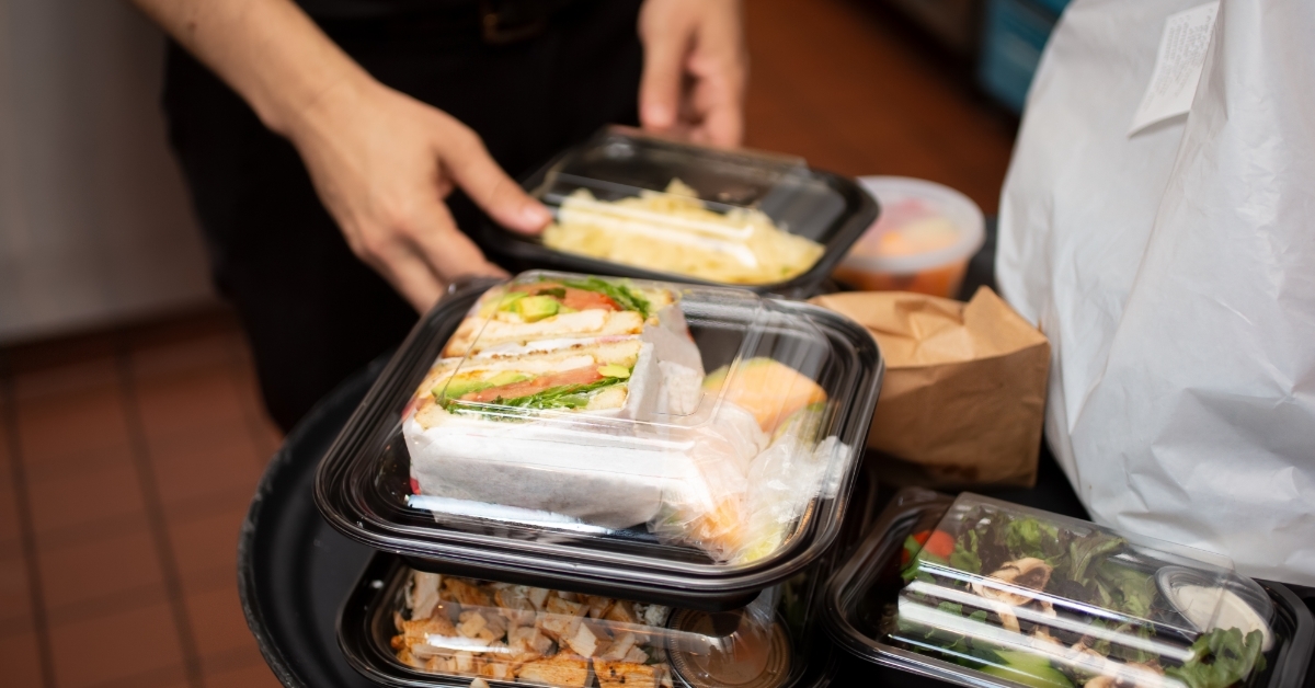 man unpacking food packages at home