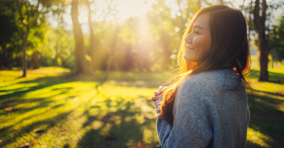 asian woman standing among nature