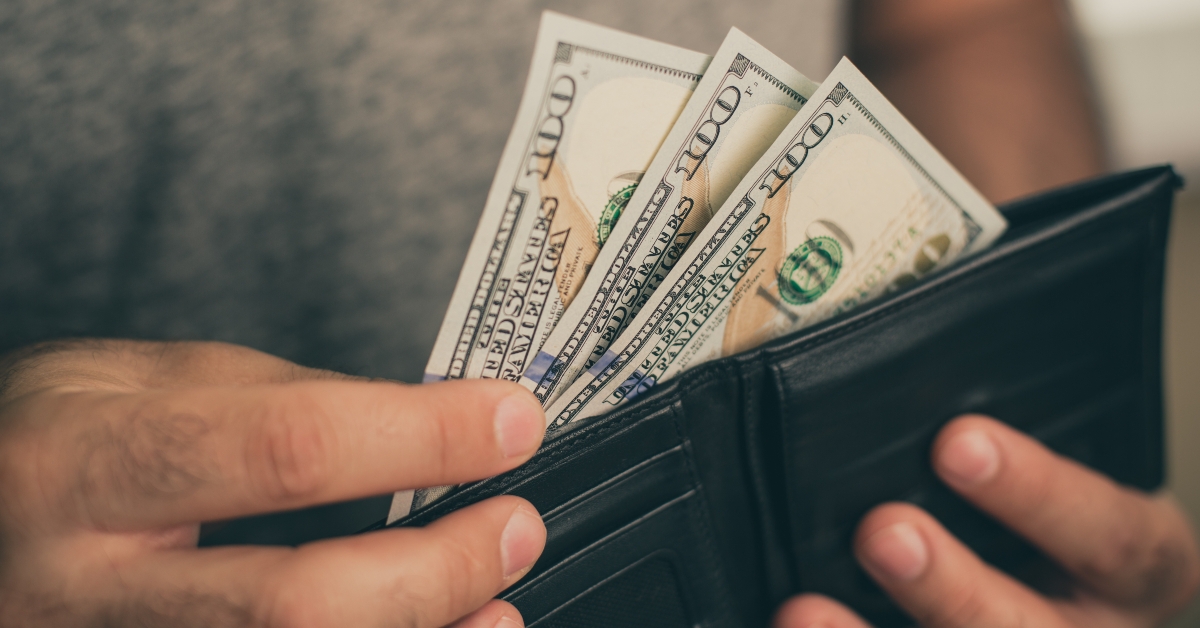 man looks in the wallet