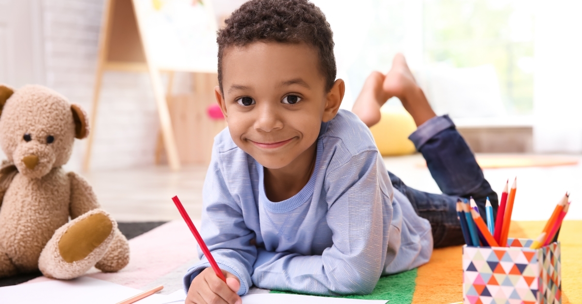 African-American boy drawing indoors