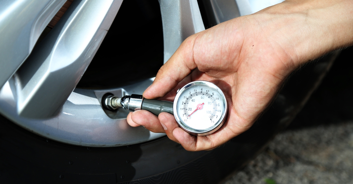 hand holding pressure gauge