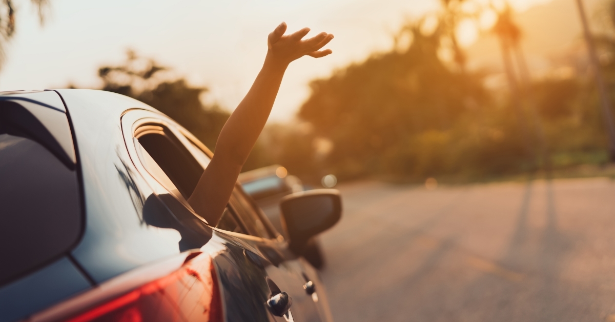 girl enjoying road trip in car