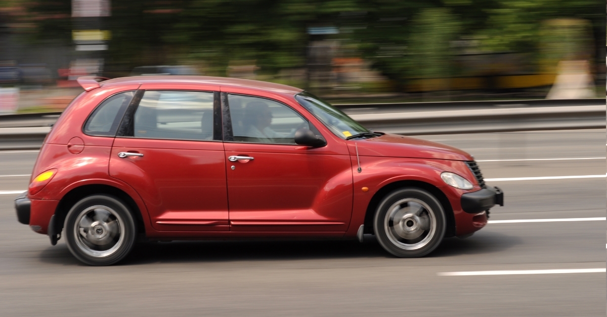 red car in motion on street