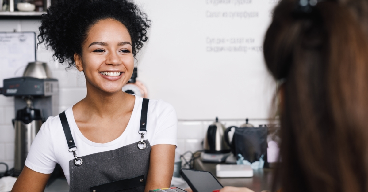 Customer paying with mobile at cafe
