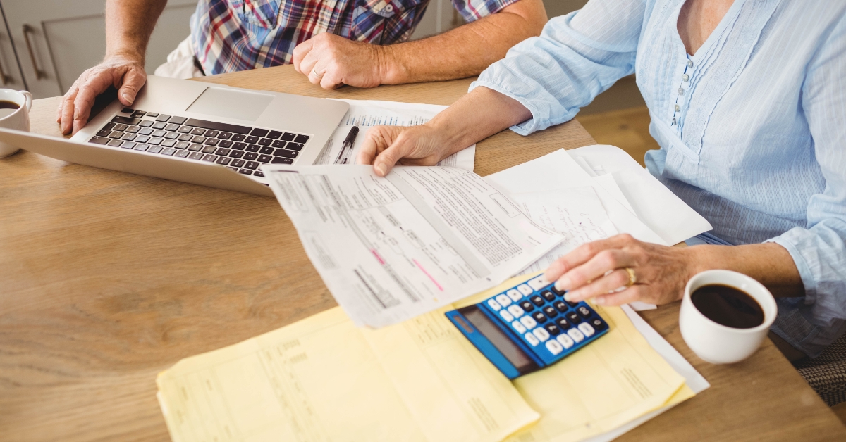 senior couple checking their bills