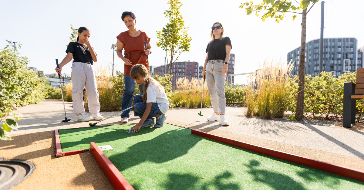family enjoying mini golf together