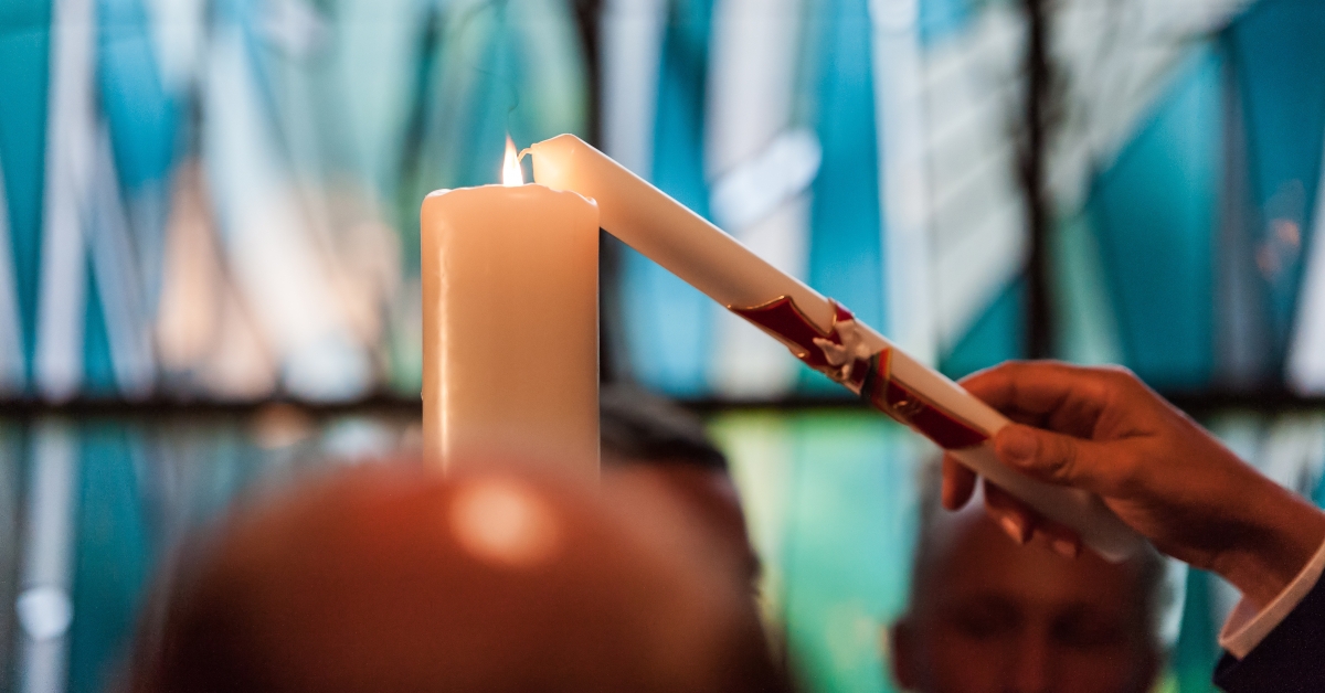 hand and candle in church