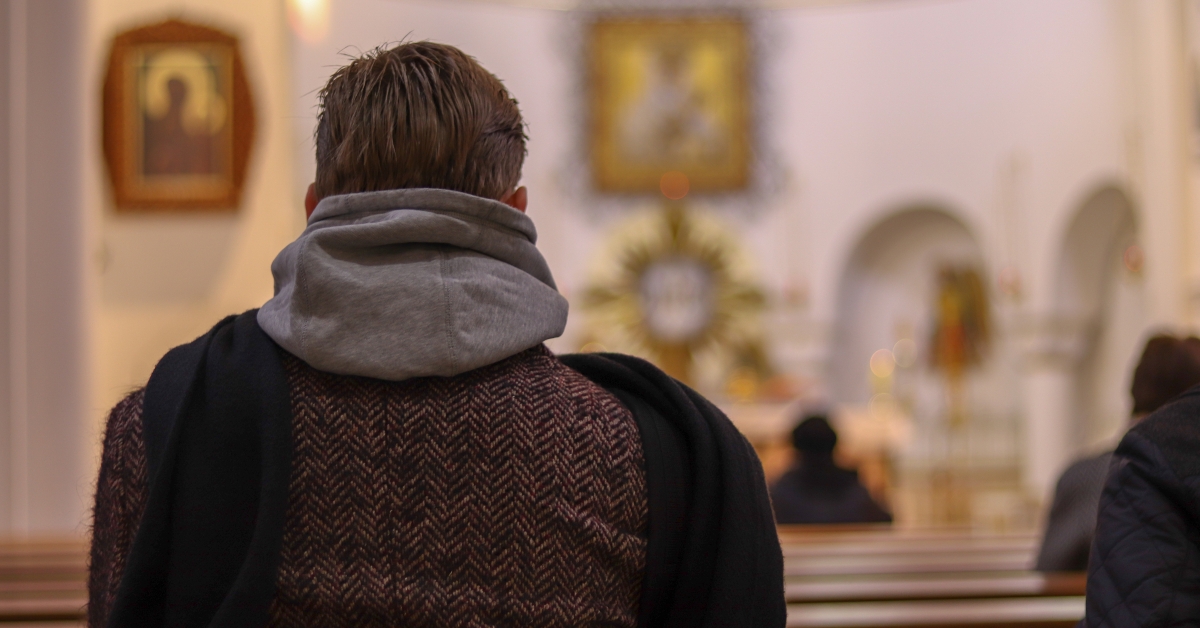man in coat in catholic church