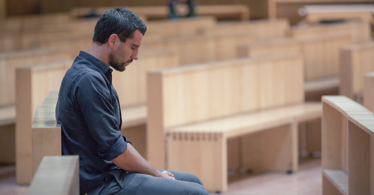 man praying in modern church