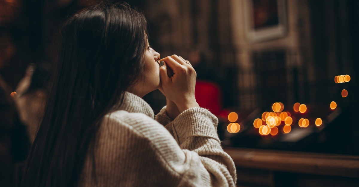 woman praying on her knees