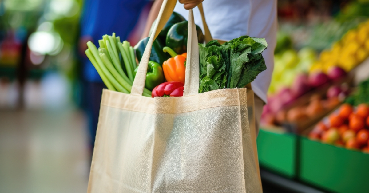 man holding reusable shopping bag