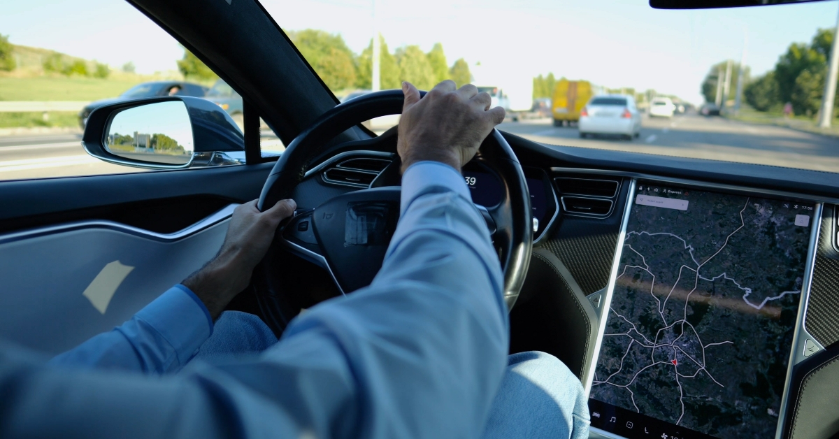 businessman holds steering wheel