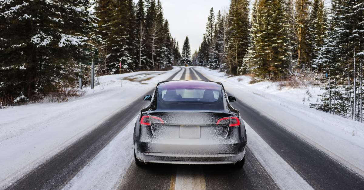 electric car driving mountains snow