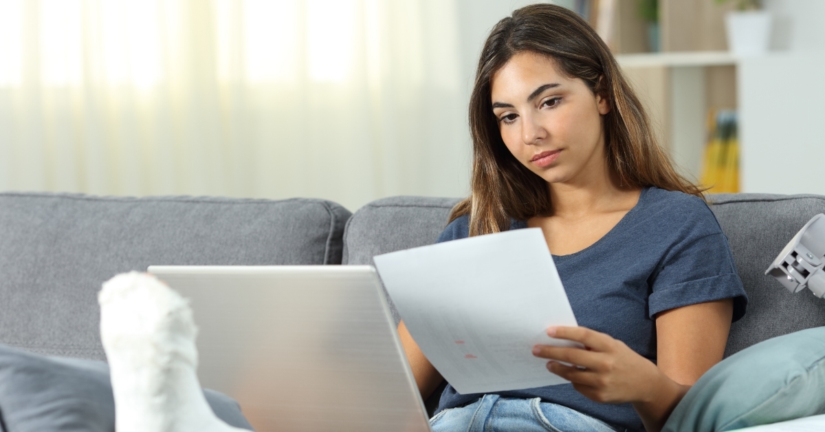 woman with leg injury working from home
