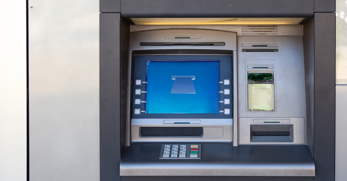 Silver atm machine in building wall