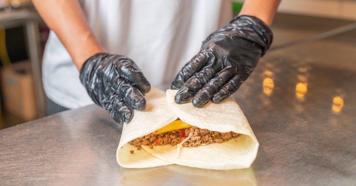 cook assembling a burrito