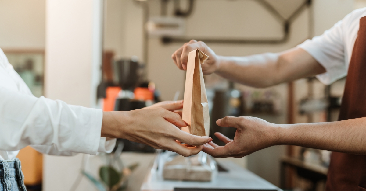 waitress giving paper bag