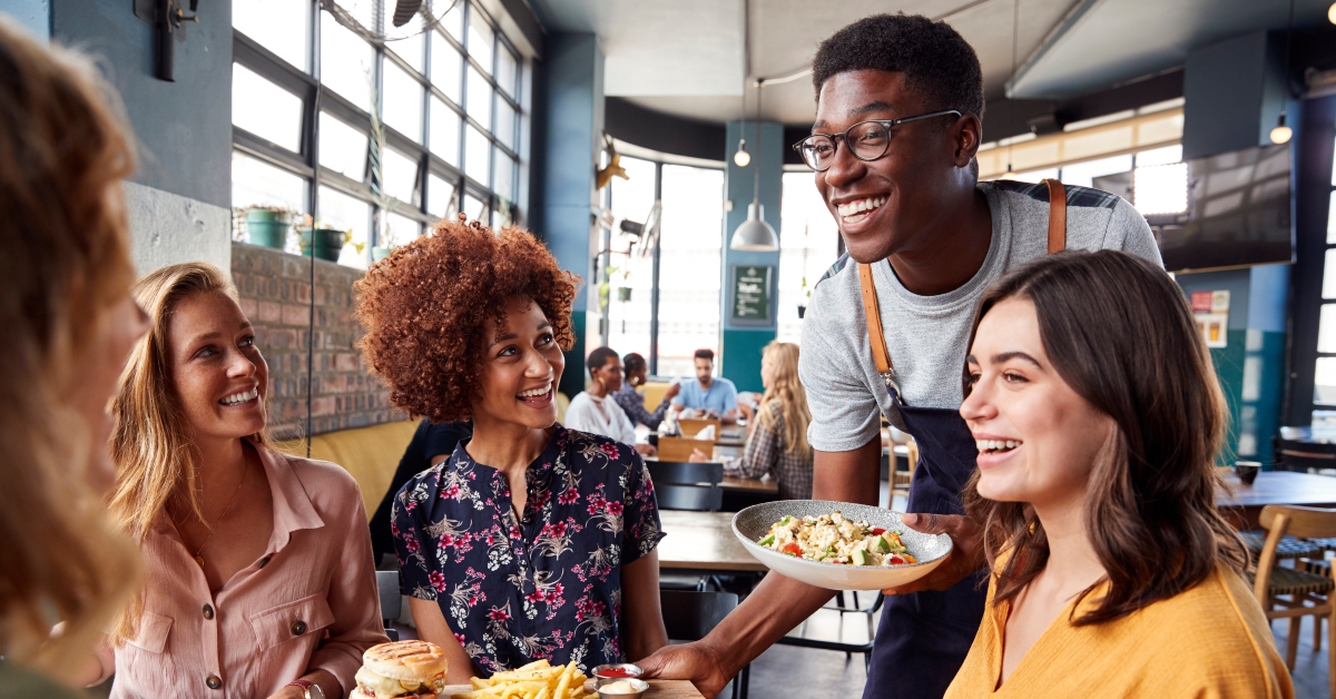 waiter serving female friends