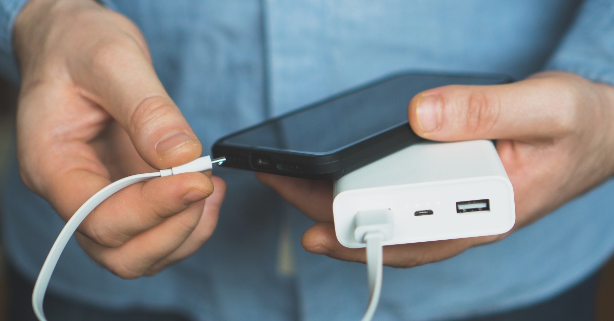man charging smartphone