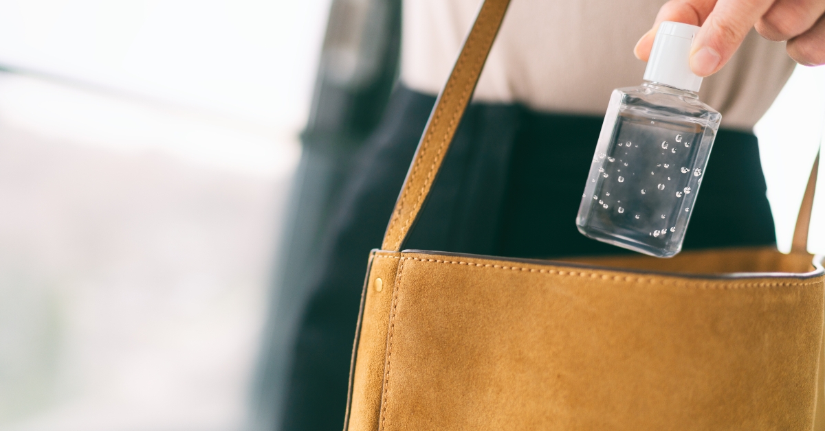 woman using hand sanitizer