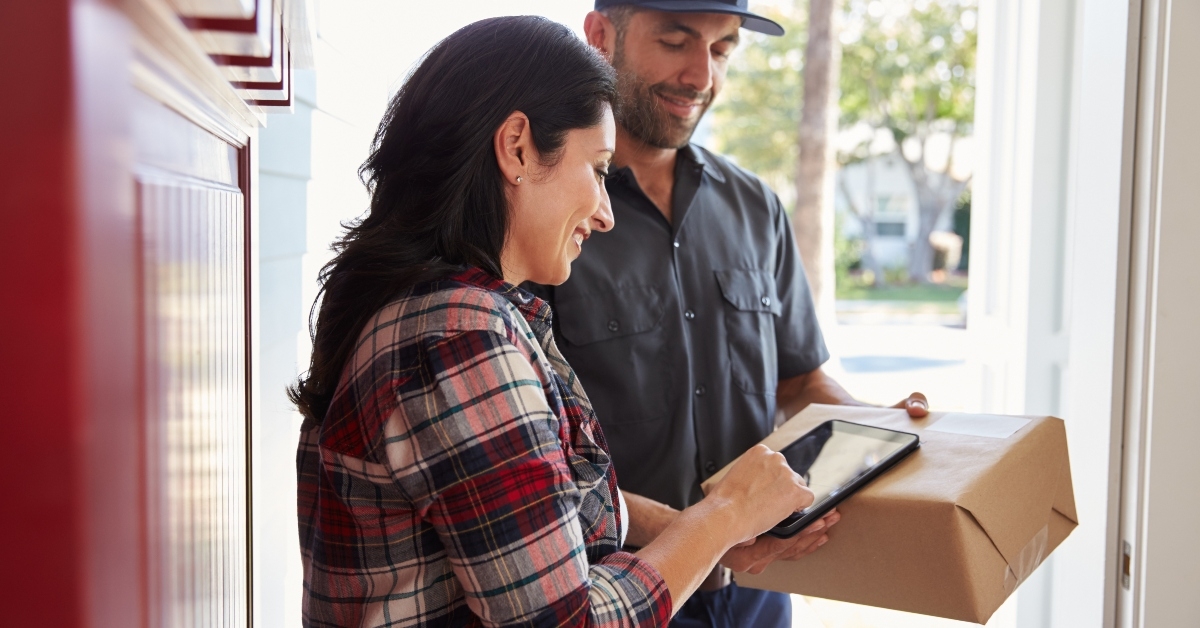woman signing for package