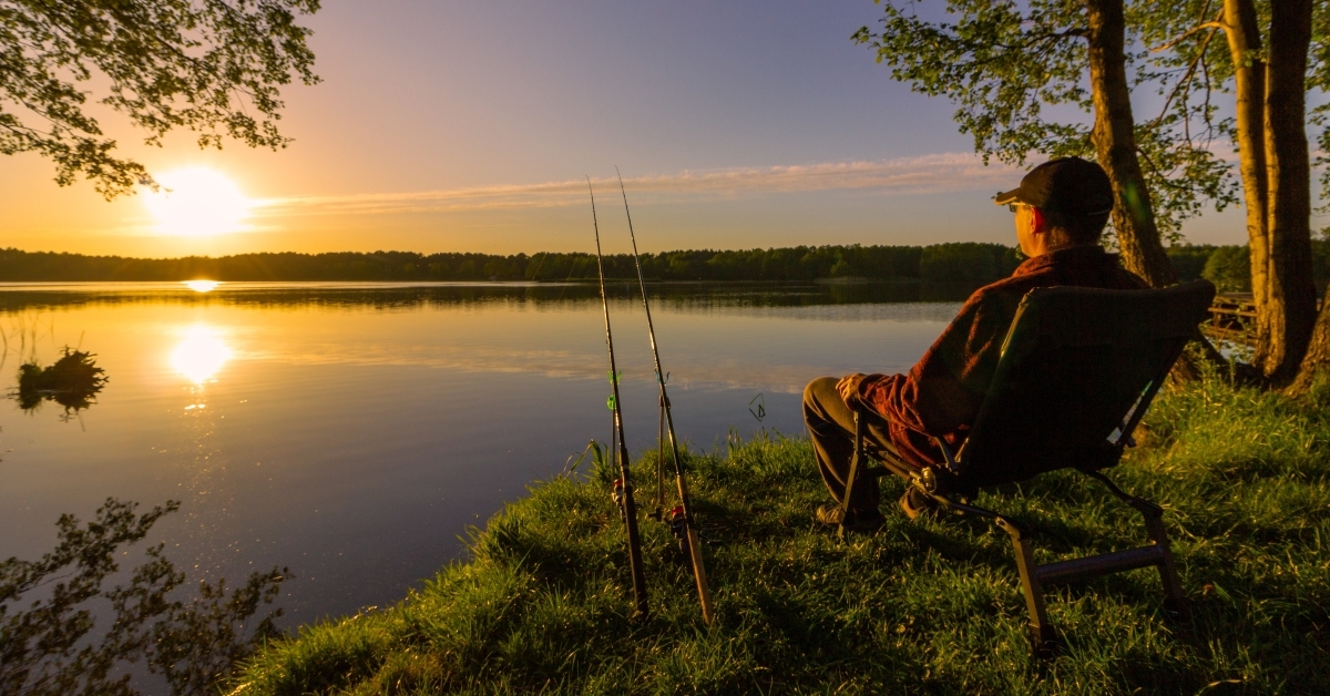 angler sitting on fishing chair 