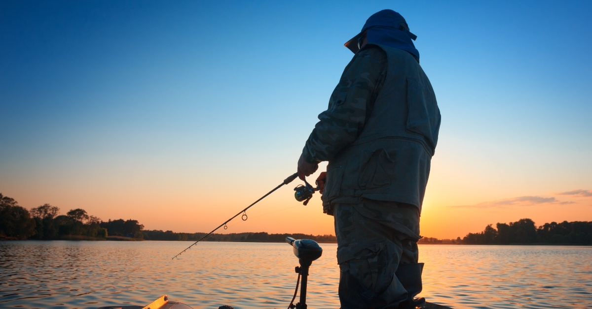 fishing in a lake at sunset