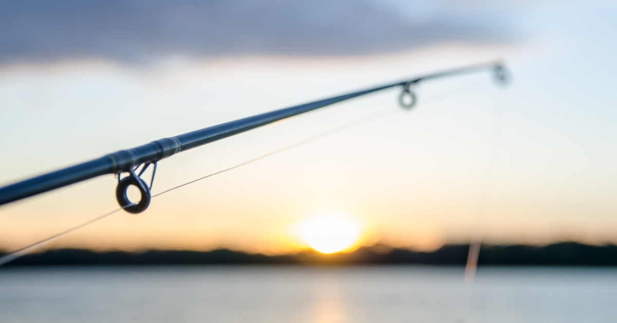 fishing on a lake before sunset
