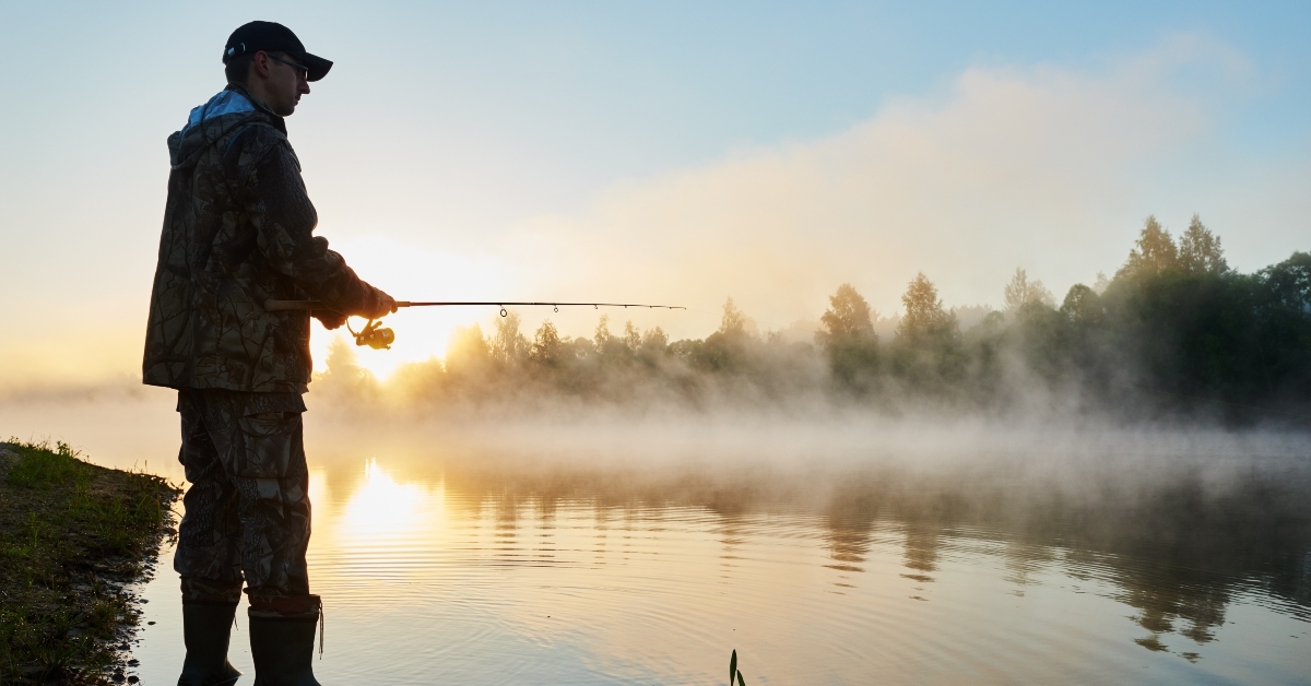 fisher fishing on foggy sunrise