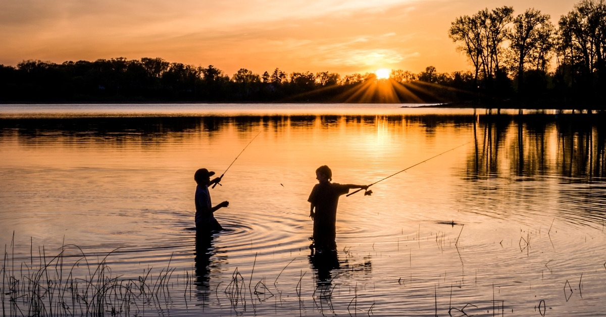 kids fishing under sunset