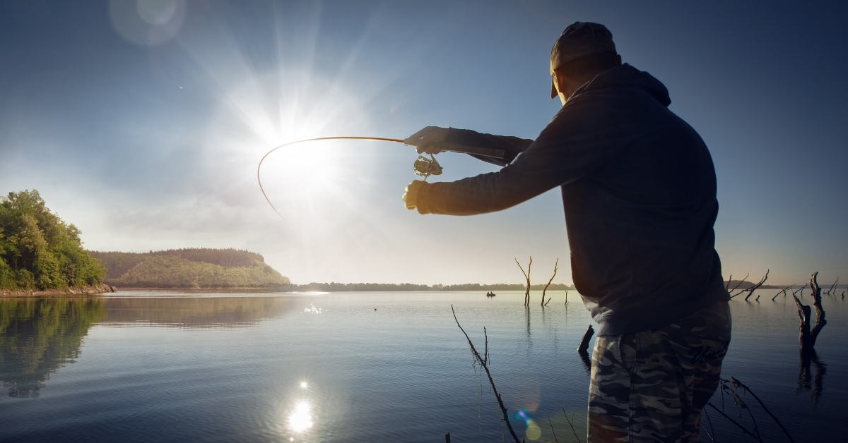 man fishing on a lake