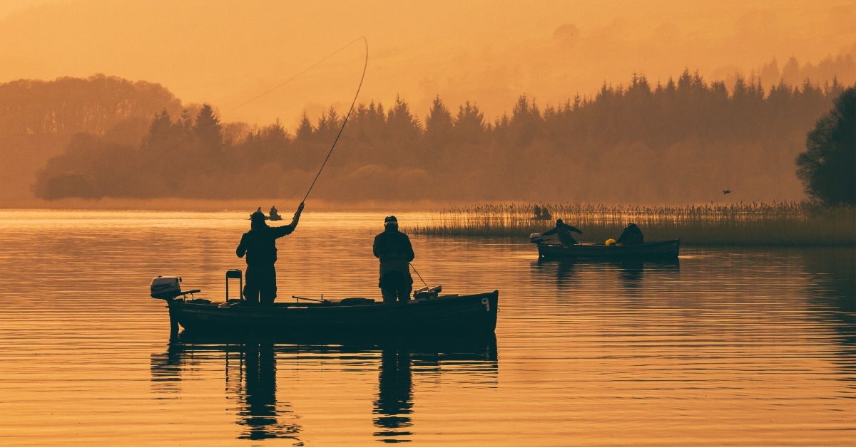 silhouette of man fishing 