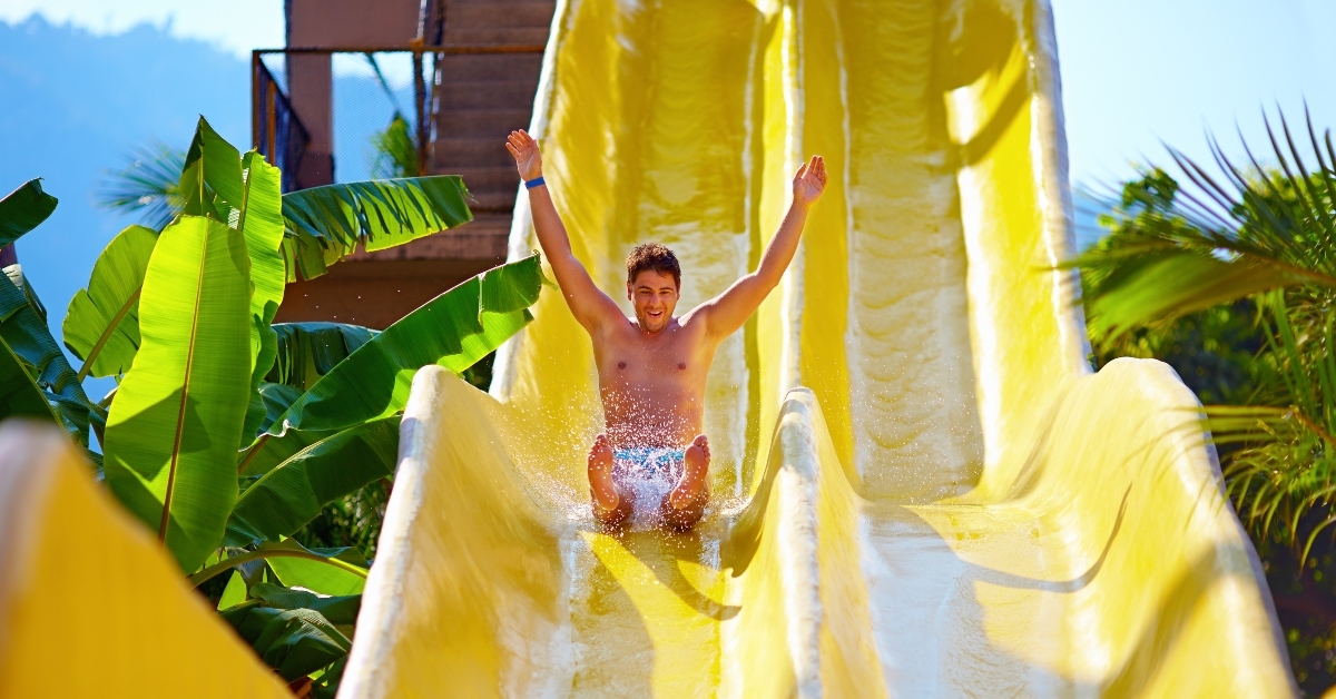 man having fun on water slide