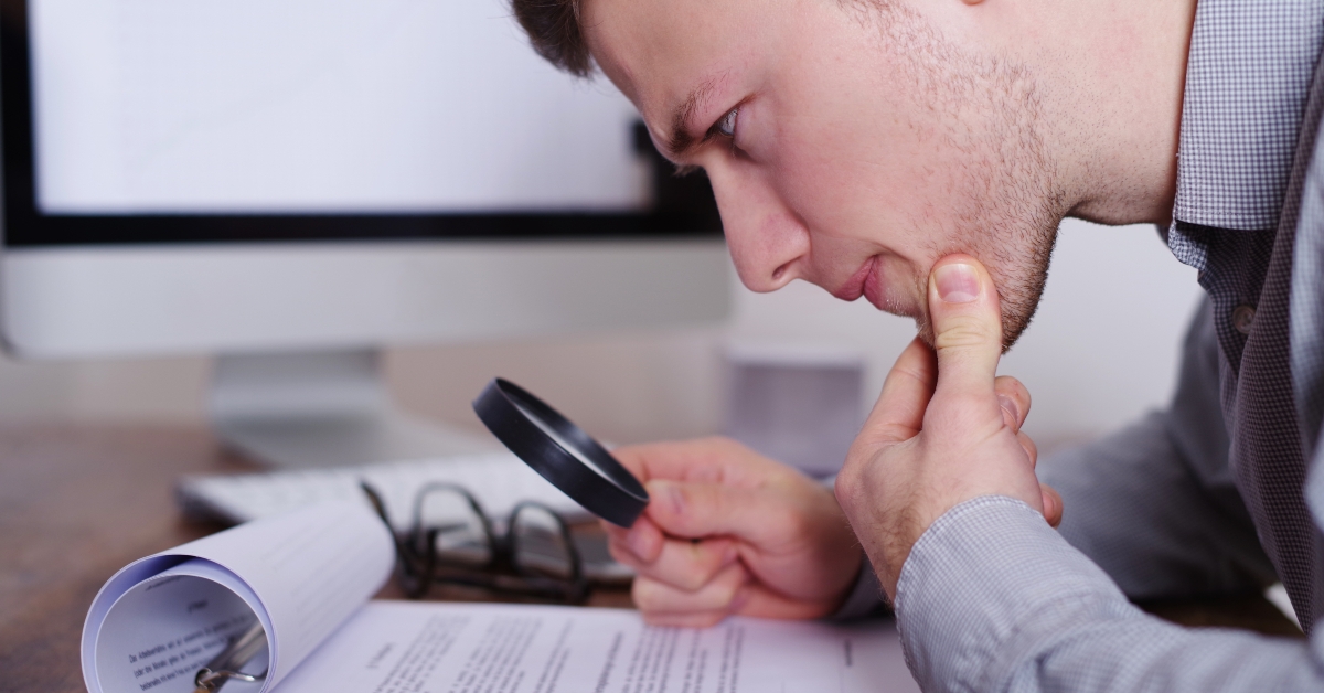 man using magnifying glass