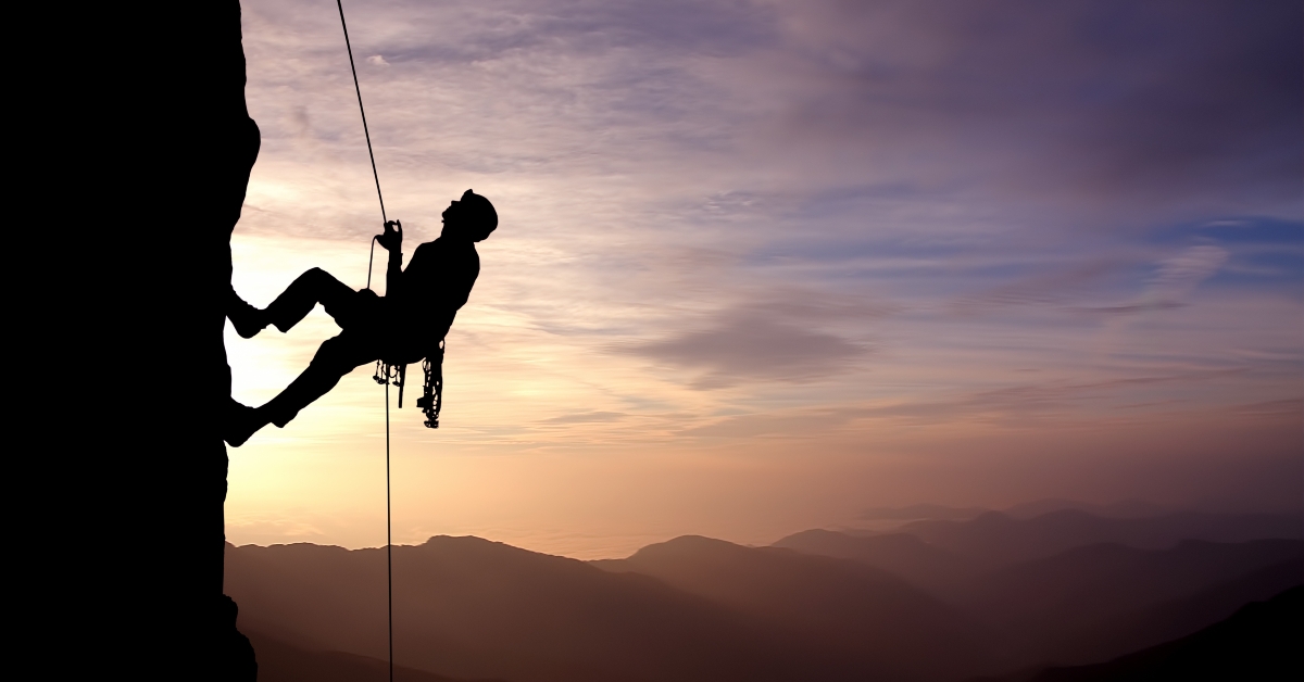 silhouette of rock climber
