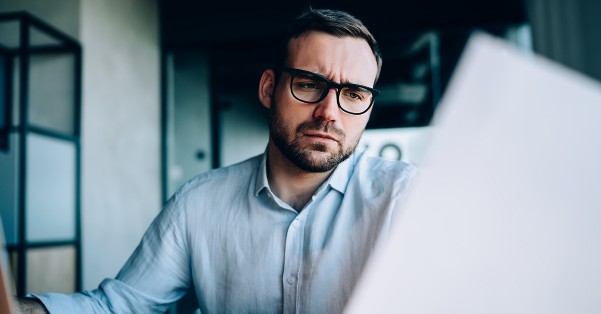 stressed man reviewing financial report