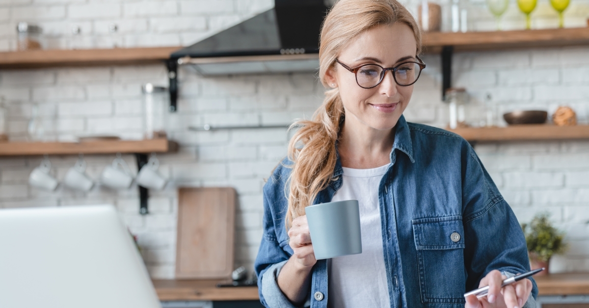 woman reviewing bills while having coffee