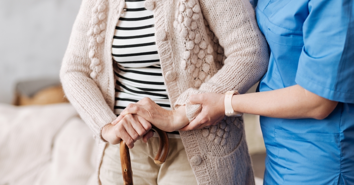 gentle trained nurse helping mature patient
