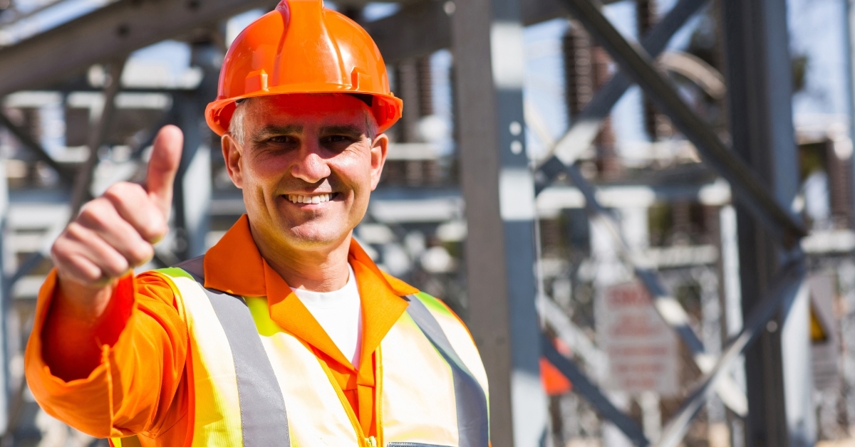 happy male electrician giving thumb up