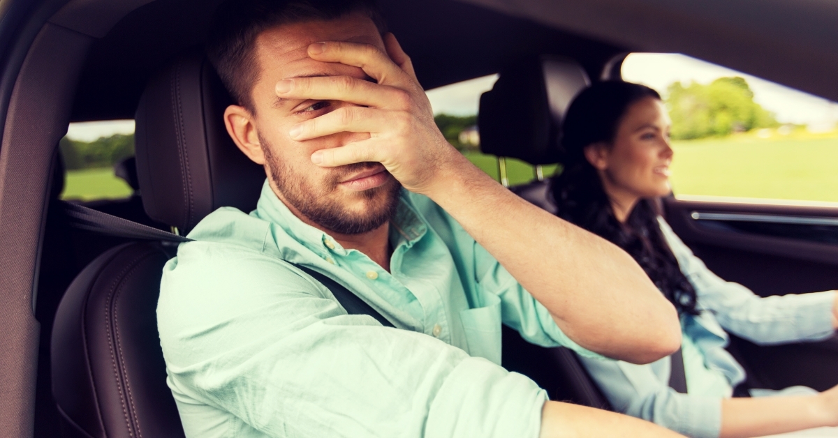 woman learning driving with scared husband