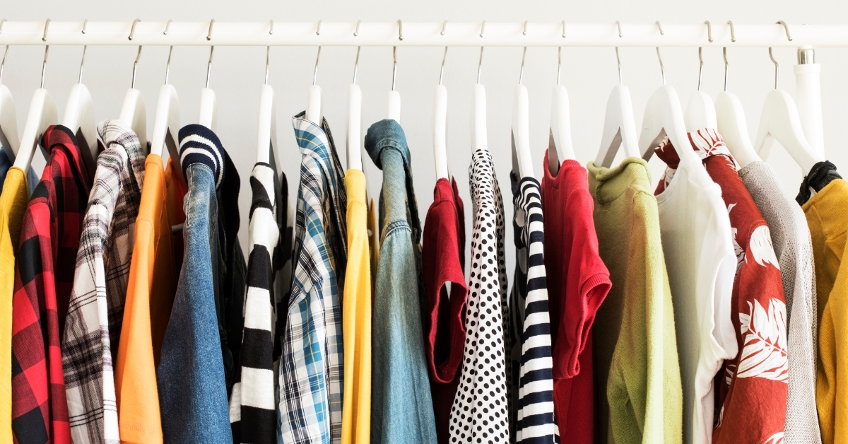 Collection of clothes hanging on rack
