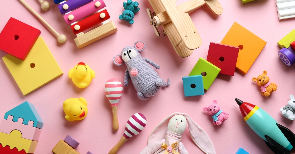 Different toys on pink background