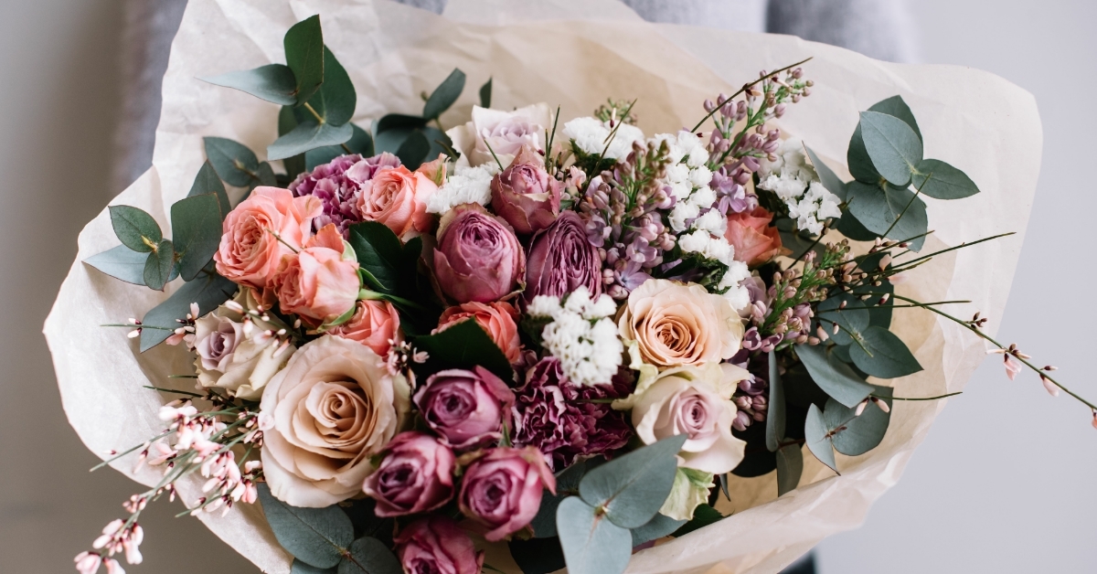 female florist holding blossoming flower bouquet