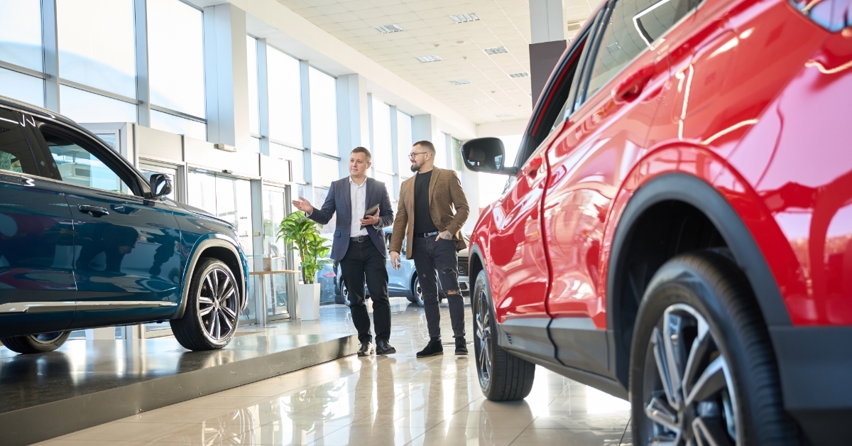 Salesman showing cars to male customer 