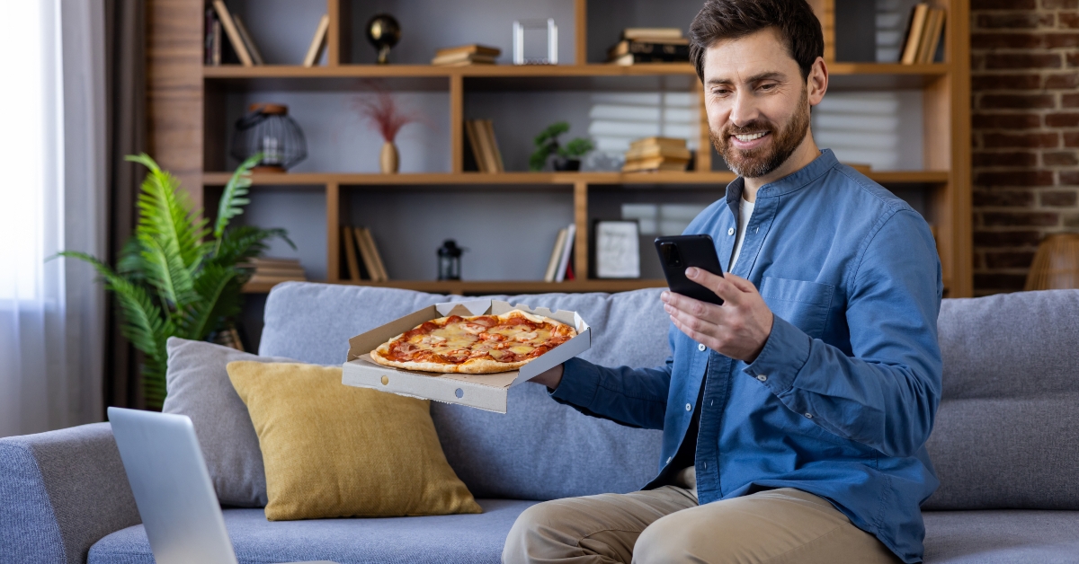smiling man enjoying pizza