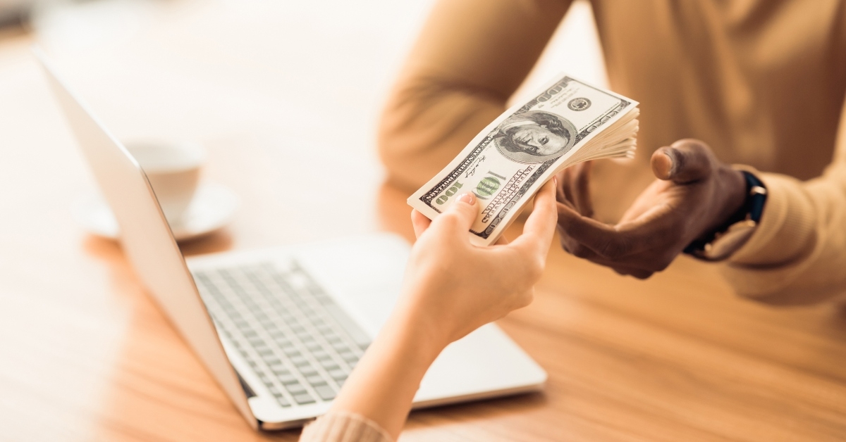 businessman taking money from woman